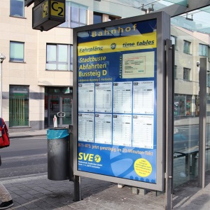 Large format printing of bus timetable with light by day