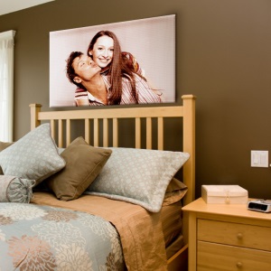 Photo of a couple 800 x 800 printed on canvas hung over a bed 